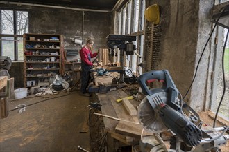 Young man builds a table in his workshop, Mecklenburg-Vorpommern, Germany, Europe