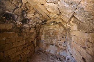 Old, rustic interior with stone walls and structural details, tomb of Cleovoulos the Lindian,