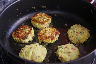 Swabian cuisine, preparation savoy cabbage, wild boar medallions with savoy cabbage cakes, frying