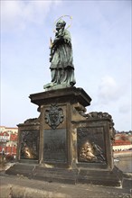 The bronze statue of St John Nepomuk on Charles Bridge, Prague, Czech Republic, Europe