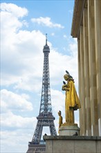 Eiffel Tower and golden statue Les Oiseaux (a woman feeding pigeons) by Louis Brasseur, street