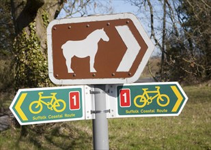 Sign for cycle route and pointing to Suffolk Punch horse tourist attraction of Easton Farm Park, at