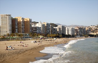 Playa de Malaguera sandy beach people sunbathing by the sea, Malaga, Spain, Europe