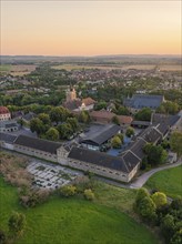 Building and village at dusk with fields in the background, Allstedt, Harz, Germany, Europe