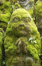 Close-up of moss-covered stone statue of rakan, the disciple of Buddha, Otagi Nenbutsu-ji temple,