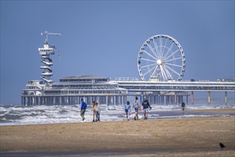 The pier and Ferris wheel at the Scheveningen beach, heavy swell, Netherlands