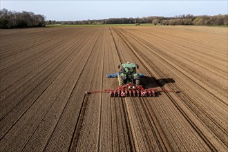 Sugar beet being sown in spring, precision sowing with precision seed drill, behind a tractor,