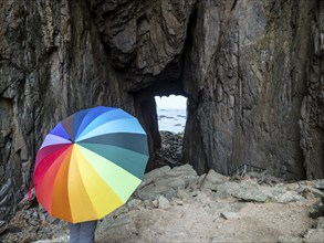 Woman with colorful umbrella, Torghatten cave, Torghatten mountain, Brønnøysund, Norway, Europe