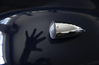 Car Lamp and a Shadow of a Hand on an Old Classic Car in Switzerland