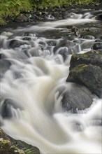 Detail of water flowing over boulders in the River Garry in Glengarry Forest, Lochaber, Scottish