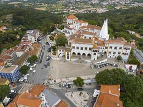 Aerial view of a historic palace surrounded by urban buildings and green areas, Royal Palace,