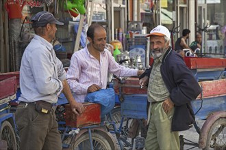 Turkish men chatting in a shopping street in the city Van, Eastern Turkey