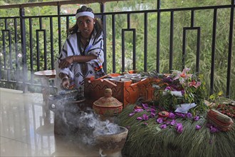 Attractive young woman, traditional coffee ceremony in a restaurant, roasting coffee beans and