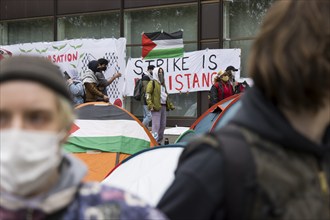 Activists and the flag of the state of Palestine during the occupation of the courtyard of Freie