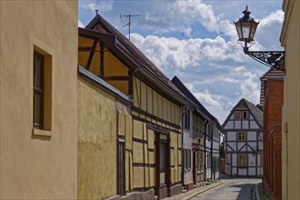 The market street with half-timbered houses and other old buildings, covered with cobblestones, in