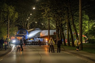 Transport of a 68 metre long, 22 tonne blade of a wind turbine, here in Schwelm, onlookers, with a