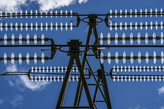 Insulators made of glass on a high-voltage line, they hang on the pylons as a suspension device