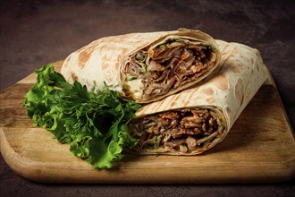 Cut shawarma, 2 pieces, on a cutting board, close-up