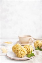 Traditional Tatar candy chak-chak made of dough and honey with cup of coffee on a white wooden