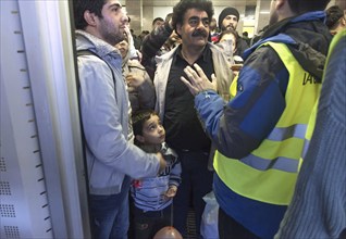 Syrian refugees arrive at Schönefeld station on a special train. They are then taken by bus to