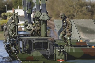 An engineer soldier stands on an amphibious vehicle of the type Amphibie M3 of the Bundeswehr,