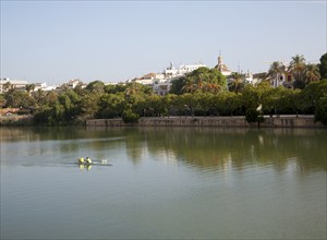 Two people rowing a boat on the Guadalquivir river, Seville, Spain, Europe