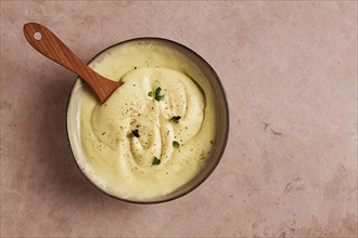 Mashed potatoes, with micro greenery and spices, homemade, on a beige table, no people, top view