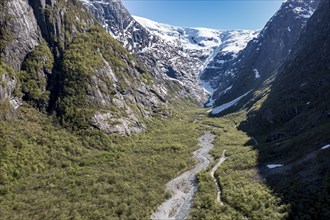 Aerial view of valley and gravel mountain road to glacier Kjenndalsbreen, valley Lodalen south of