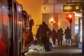 Bus stop, in the fog, passengers boarding a bus, autumn, winter, Essen, North Rhine-Westphalia,