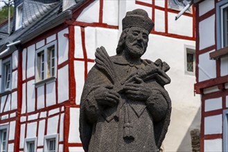 Monreal, idyllic half-timbered village in the Elz valley, figure of Nepomuk, the bridge saint, in