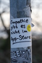 Sticker on a lamppost, empathy is not available in the app store, statement on more personal