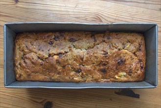 Freshly baked English tea cake with sultanas in a baking tin, Bavaria, Germany, Europe