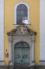 Entrance portal to the monastery church of St Hedwig, 1755, above the alliance coat of arms of the