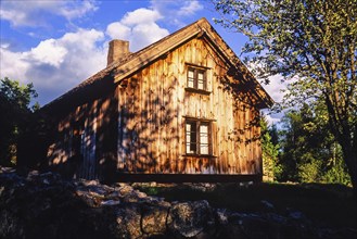 Old rural wooden cottage in the shade in the countryside, sweden