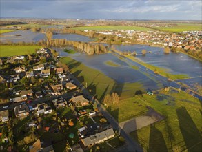 Aerial view of residential area next to lakes due to flooding, under cloudy sky, Christmas, 2023,