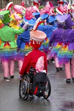 Rose Monday parade in Düsseldorf, street carnival, foot groups, carnivalist in a wheelchair