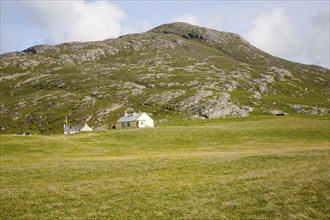 Small croft houses in rocky setting, at Allathasdal, Barra, Outer Hebrides, Scotland, UK