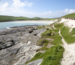 Rocky headland and sandy beach at Bagh a Deas, South Bay, Vatersay island, Barra, Outer Hebrides,