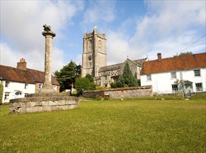 Church of St Michael and butter cross on the village green in Aldbourne, Wiltshire, England, United