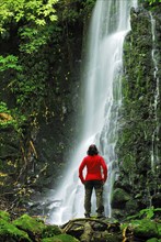 A woman looks at the Matai Falls in New Zealand, Otago, South Island, New Zealand, Oceania