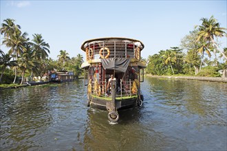 Traditional houseboat on a canal in the canal system of the backwaters, Kerala, India, Asia