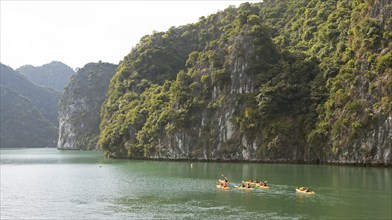 Kayakers and the karst rocks in Lan Ha Bay, Halong Bay, Vietnam, Asia