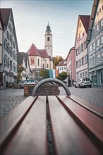 Old town with church and bench on cobblestones in the morning light, Horb, Black Forest, Germany,