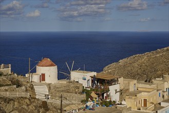 Rustic coastal village with windmill and direct sea view, Mediterranean charm, Colourful mountain