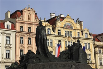 The Jan Hus Monument and historic houses on the Old Town Square, Prague, Czech Republic, Europe