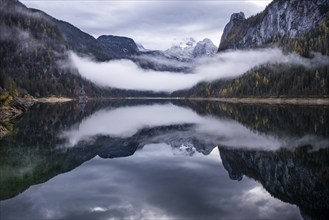 The Vordere Gosausee lake in autumn with a view of the Dachstein mountain range. The Gosaukamm on