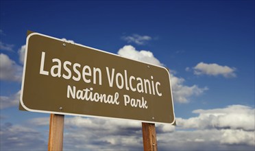 Lassen volcanic national park (california) road sign against blue sky and clouds