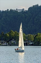 Sailing boat on Lake Tegernsee, warm evening light, above Ringberg Castle, heritage-protected