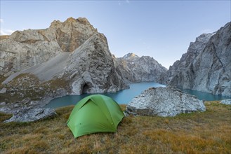 Wild camping, camping in the wilderness with a tent in front of mountain lake Kol Suu, Sary Beles