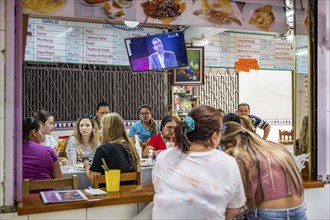 Visitors sitting at a food stall at the counter, Mercado Central de San José, San José, Costa Rica,